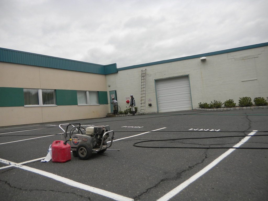 Petrol high-pressure waterblasting unit with hoses set up on site